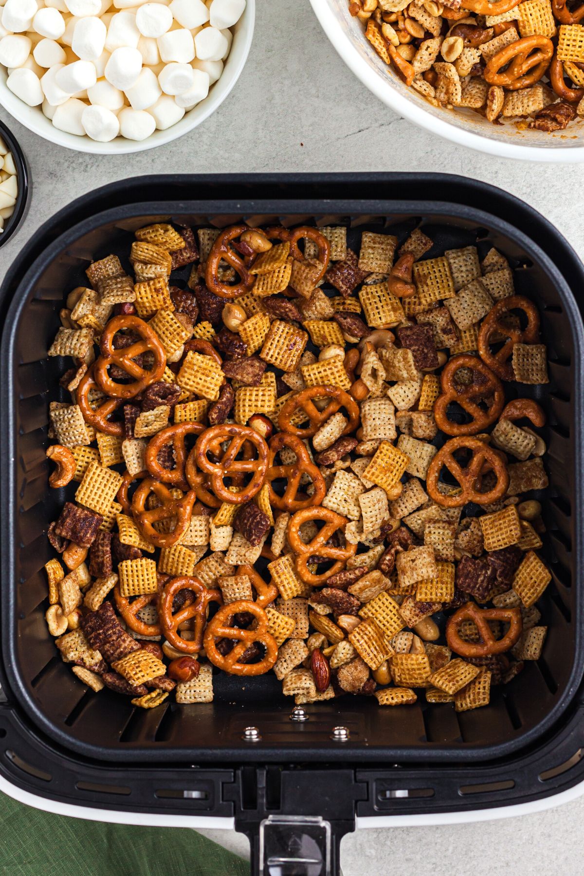 Chex mix with pretzels and nuts in the air fryer basket