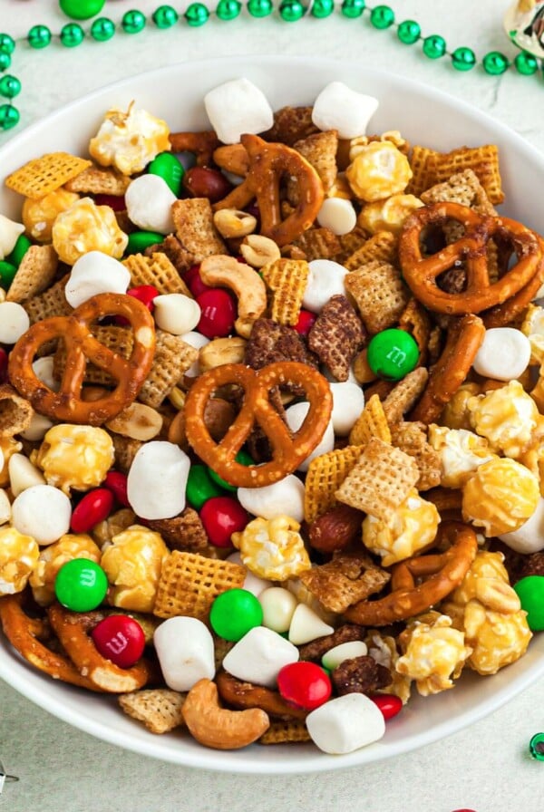 Chex mix with pretzels and nuts in a round bowl