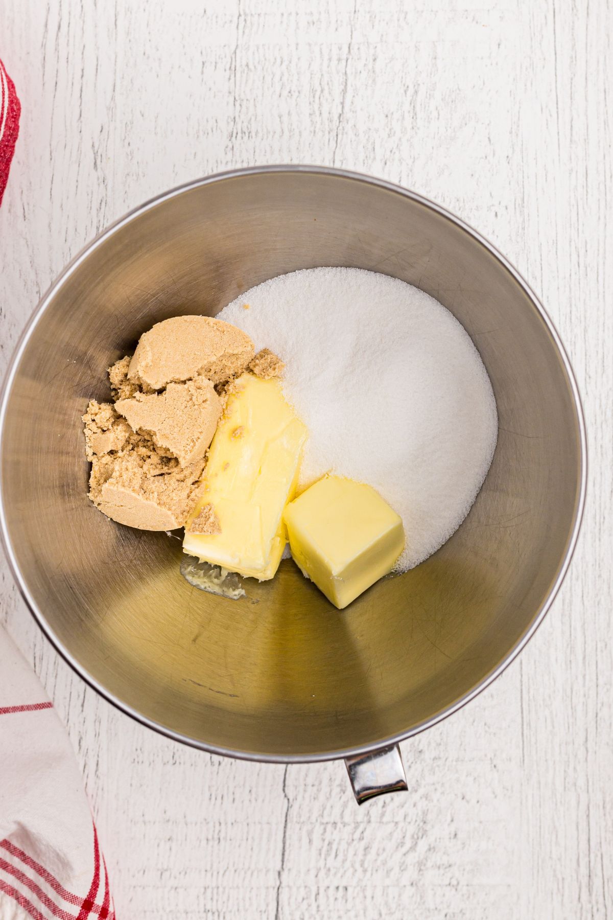 Butter with sugar and brown sugar in a large mixing bowl