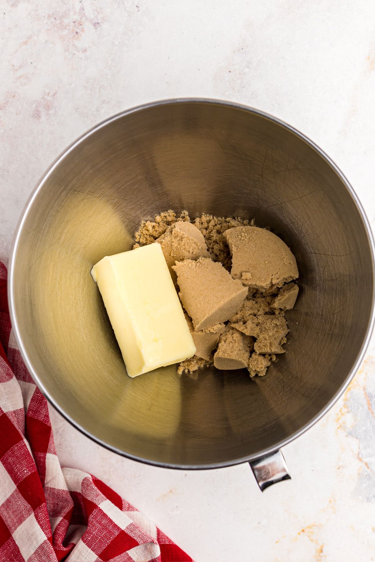 Butter and brown sugar mixed together in a kitchenaid bowl