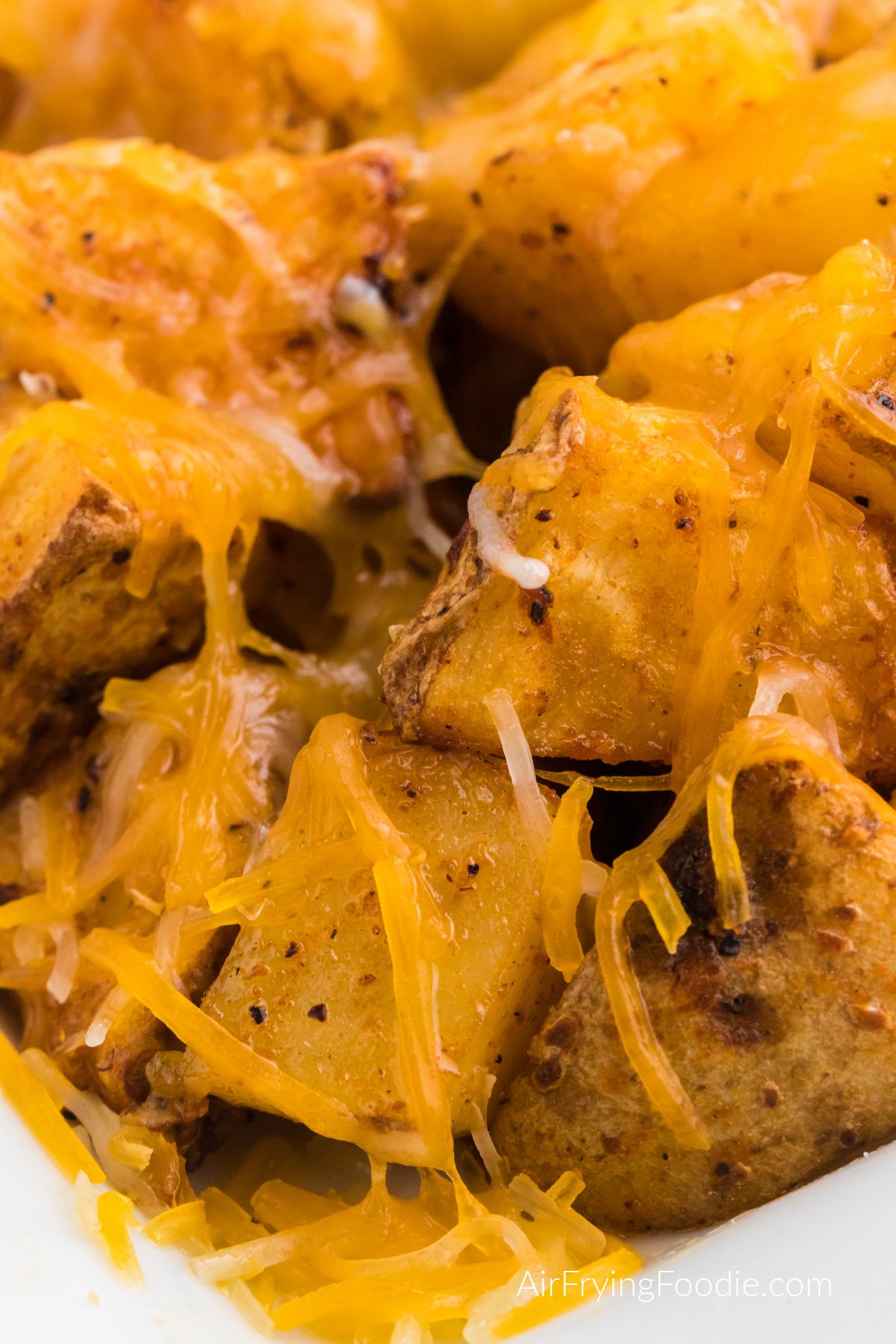 Close up photo of seasoned air fryer cheesy potatoes.