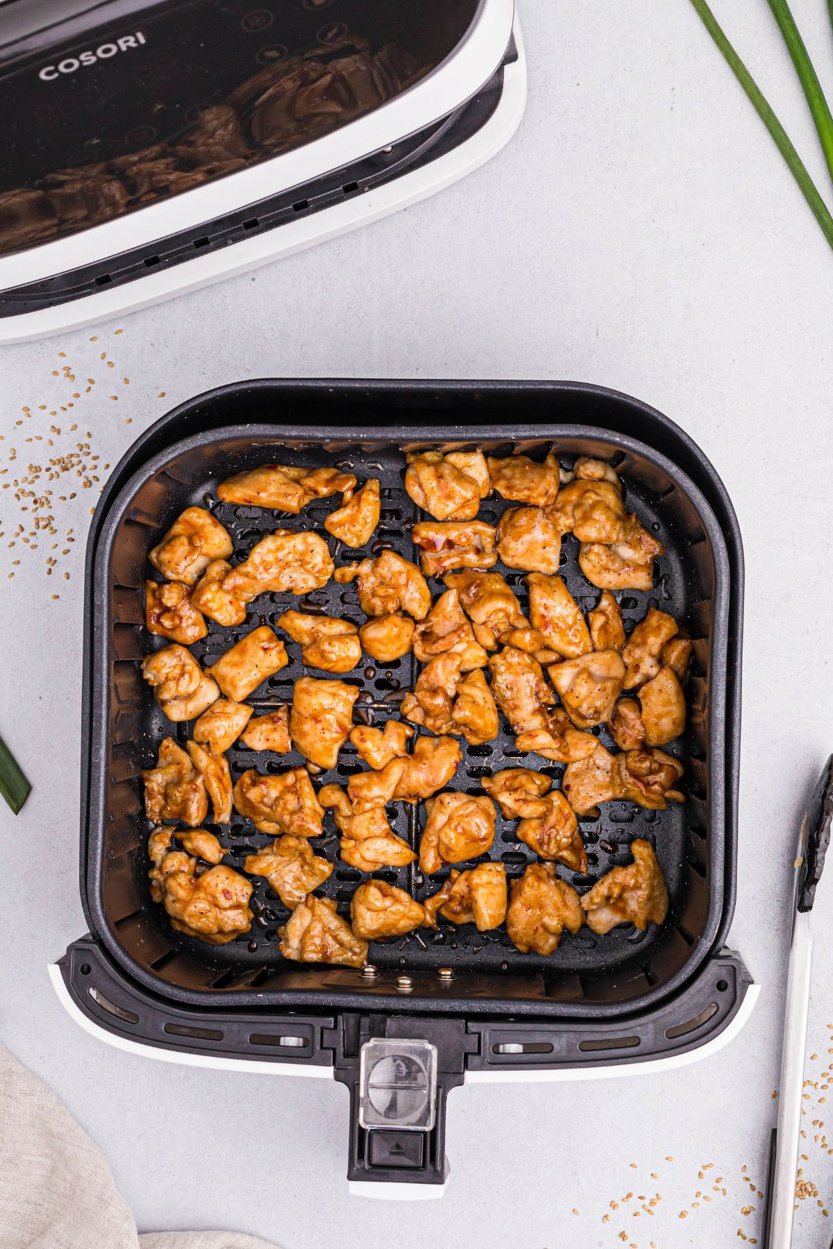 Golden cooked chicken tossed in General Tso's sauce and heated in the air fryer basket.