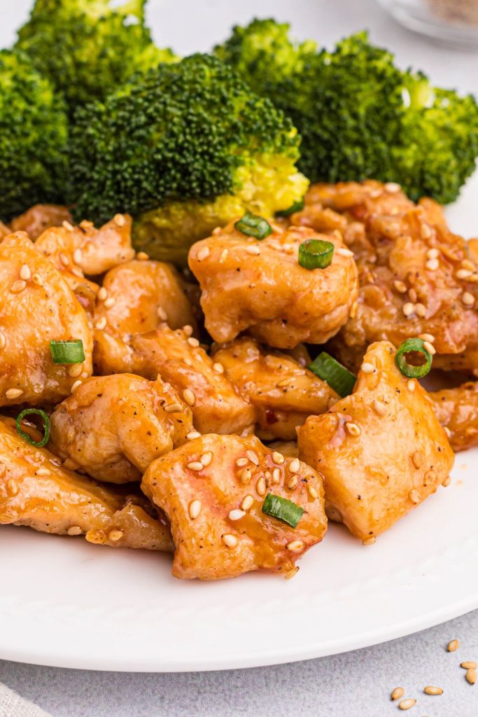 Golden juicy chicken pieces tossed in general tso's sauce and garnished with green onions and sesame seeds. 