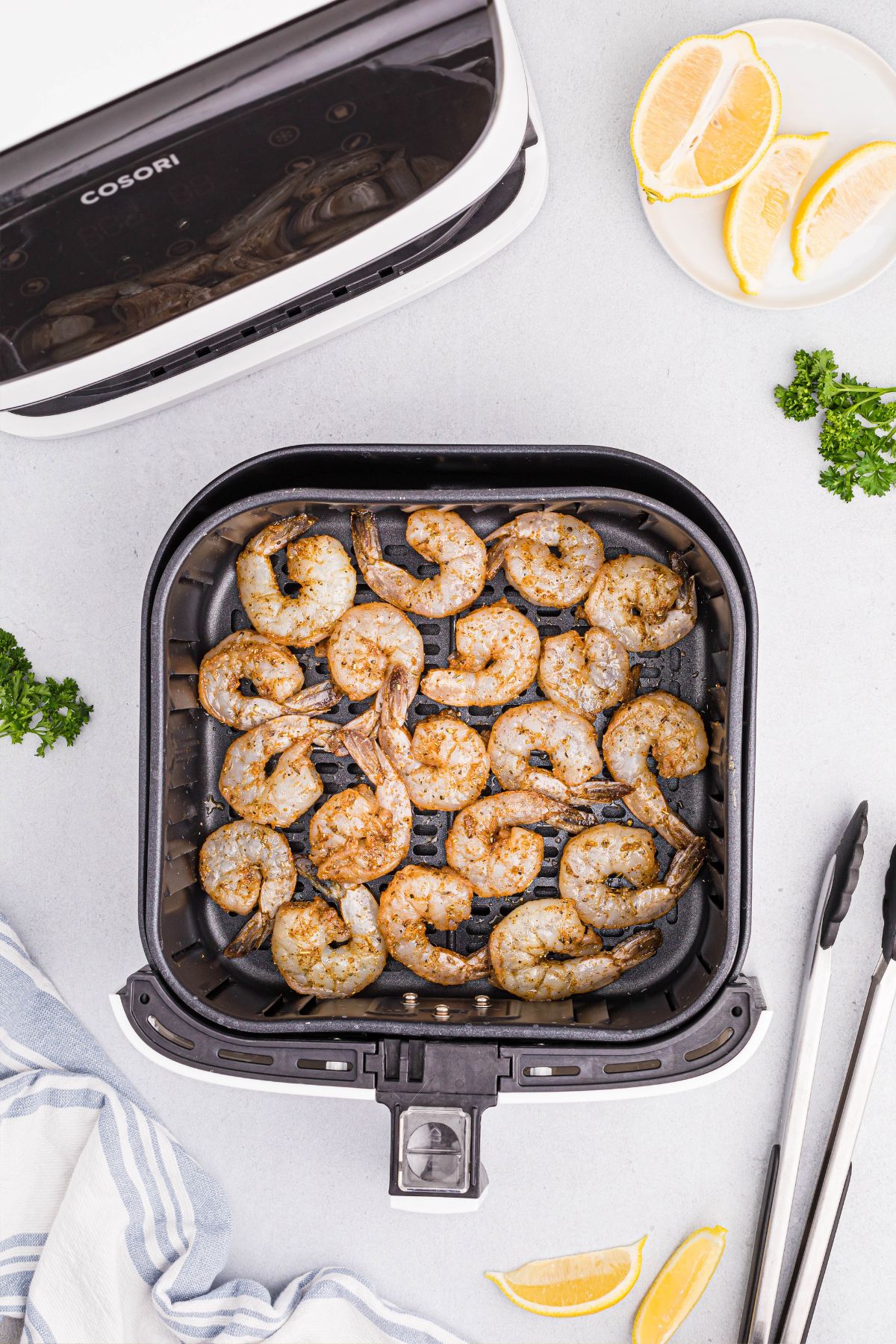 seasoned uncooked shrimp in the air fryer basket