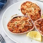 Closeup overhead shot of stuffed clams on a white plate.
