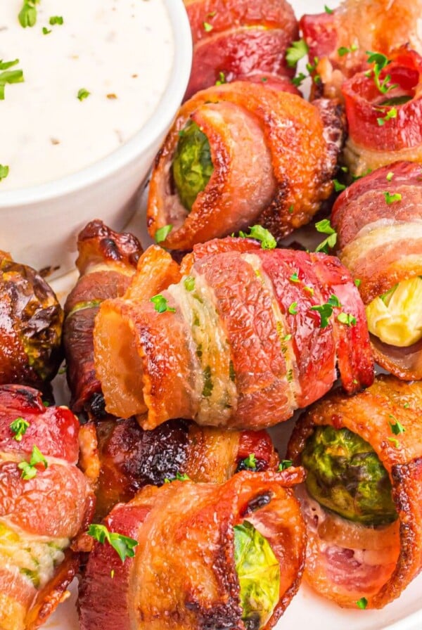 Golden crispy bacon wrapped around brussels sprouts after being cooked in the air fryer.