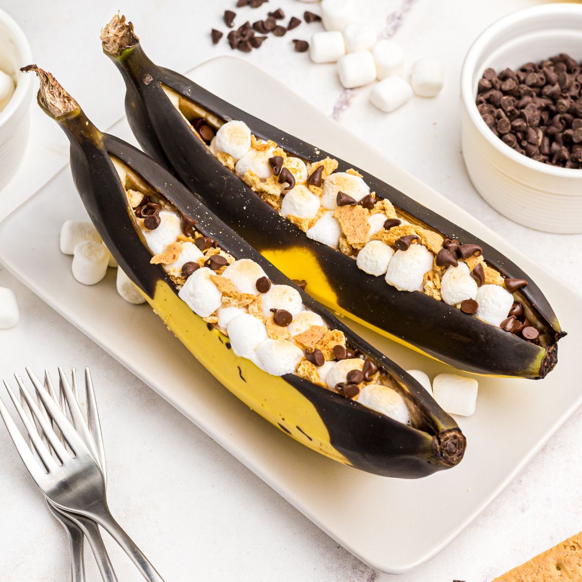 Bananas sliced open and stuffed with marshmallows and chocolate chips, then air fried.