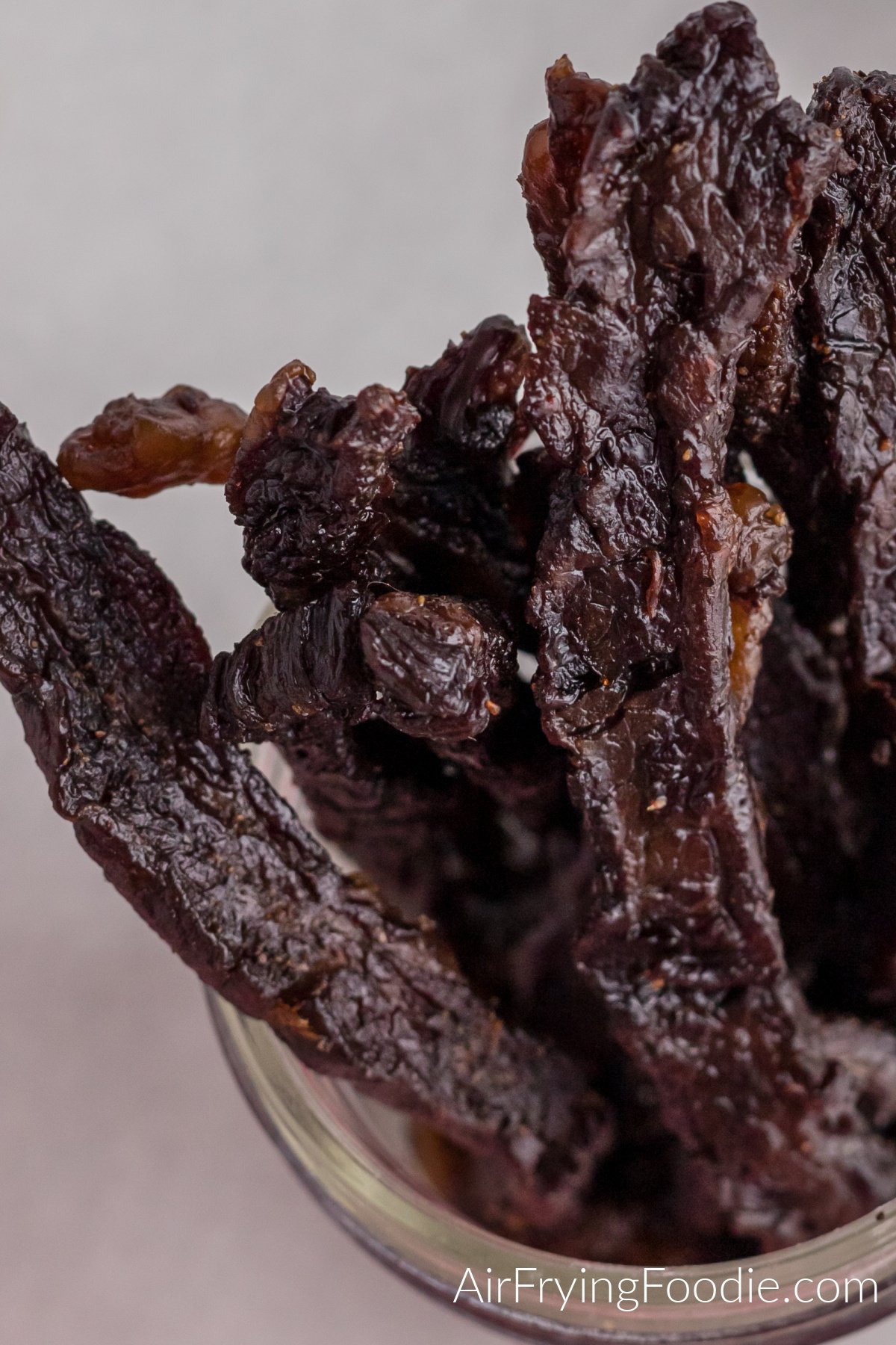 Close up photo of beef jerky in a jar that was made in the air fryer. 