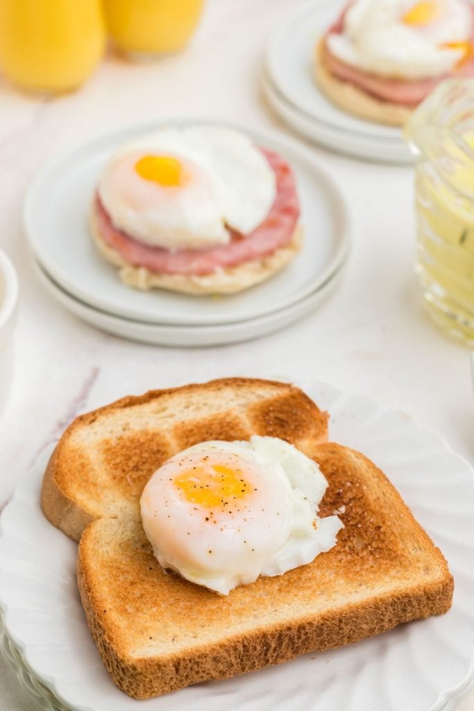Poached egg on a piece of toast on a white plate