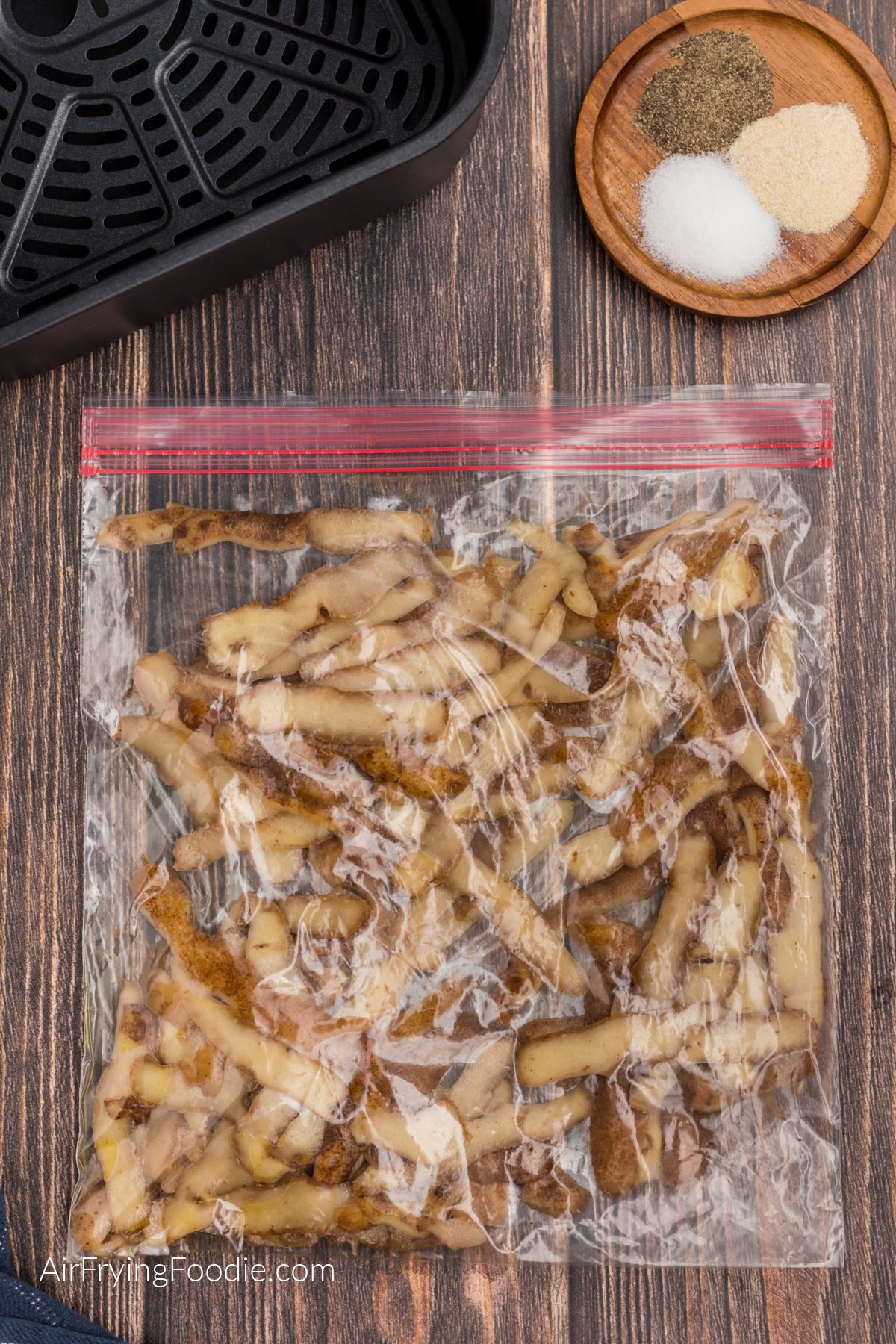 Potato peelings and oil in a plastic sealed bag.