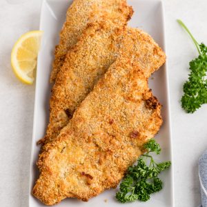 Overhead photo of air fryer fish filets on a plate, ready to serve.
