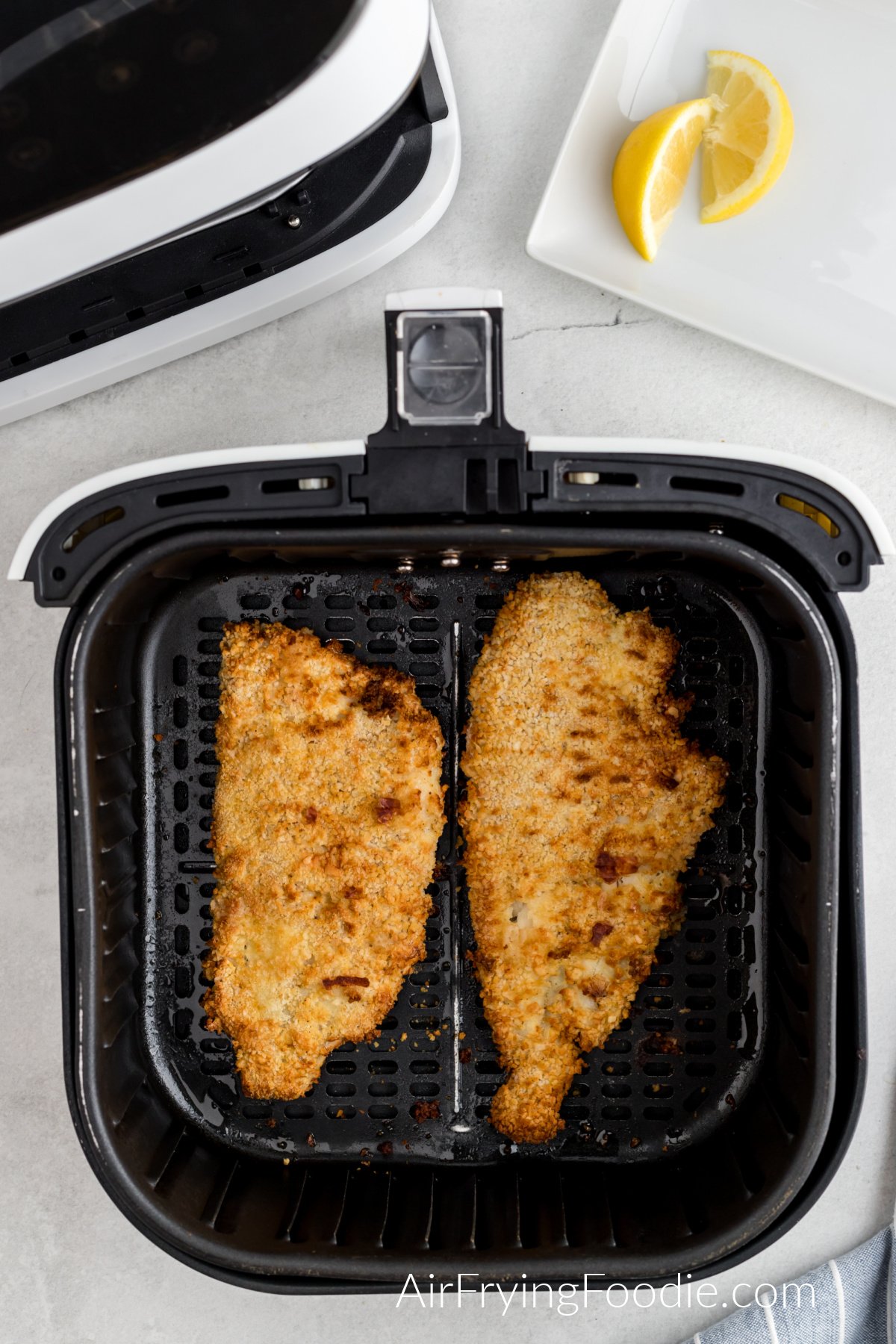 air fried fish in the basket of the air fryer.