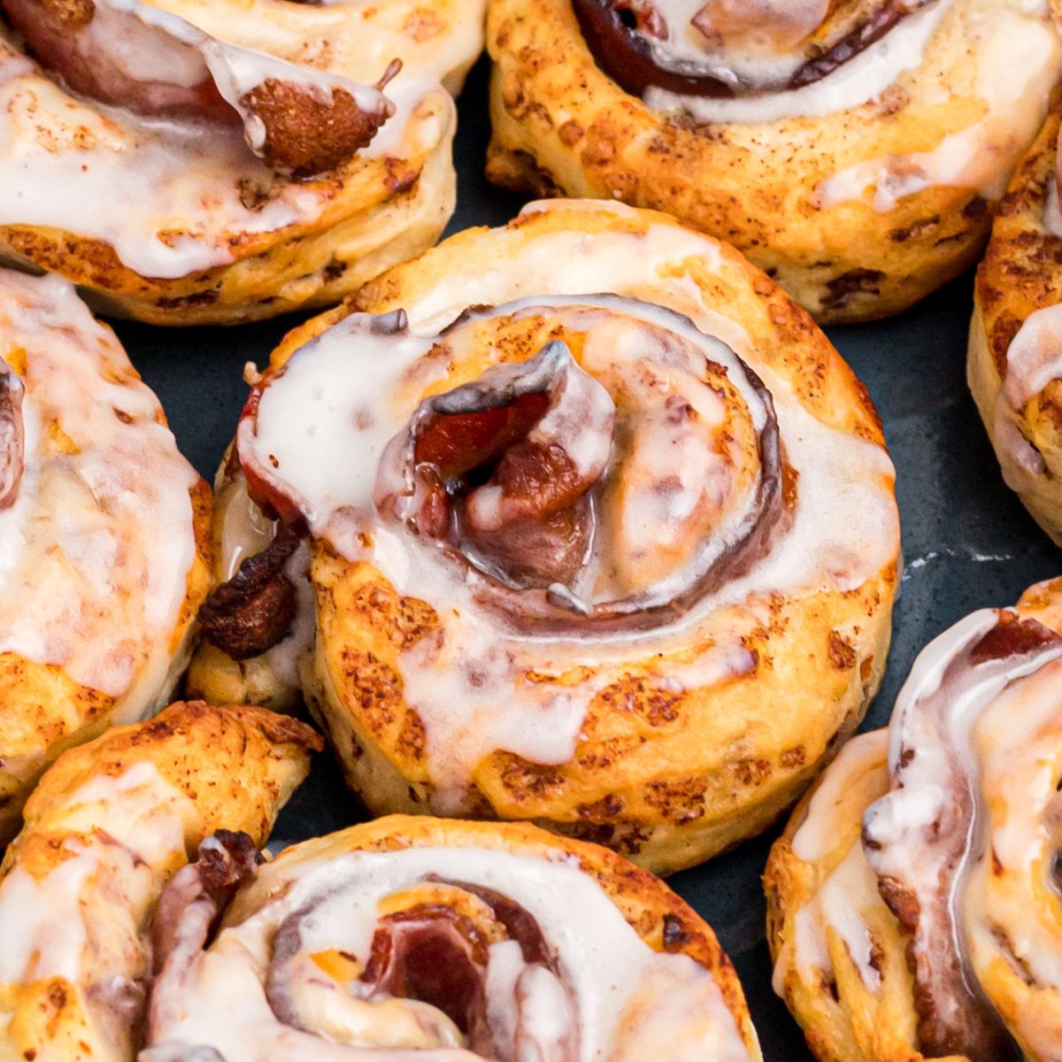 Golden cinnamon rolls air fried around a slice of bacon