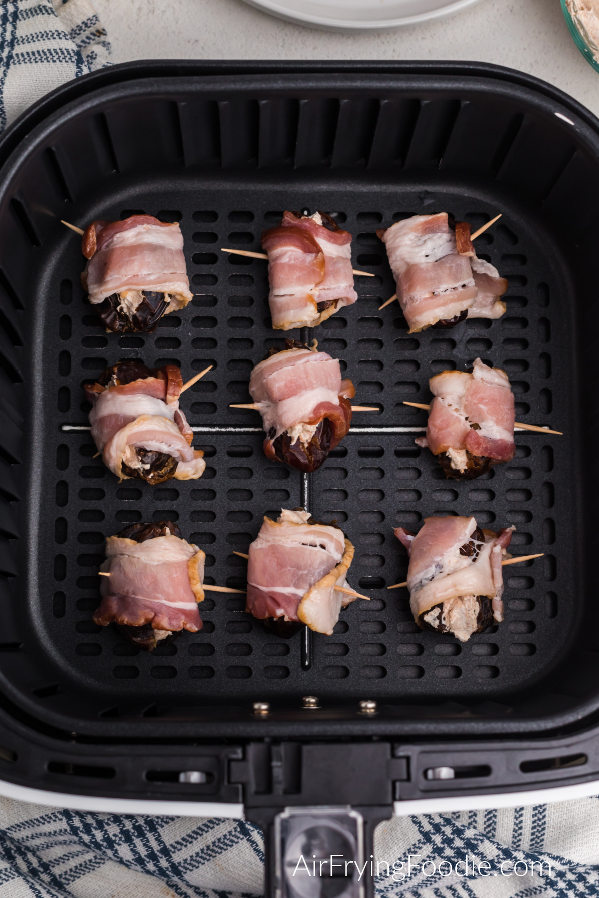 Bacon wrapped dates in the basket of the air fryer.