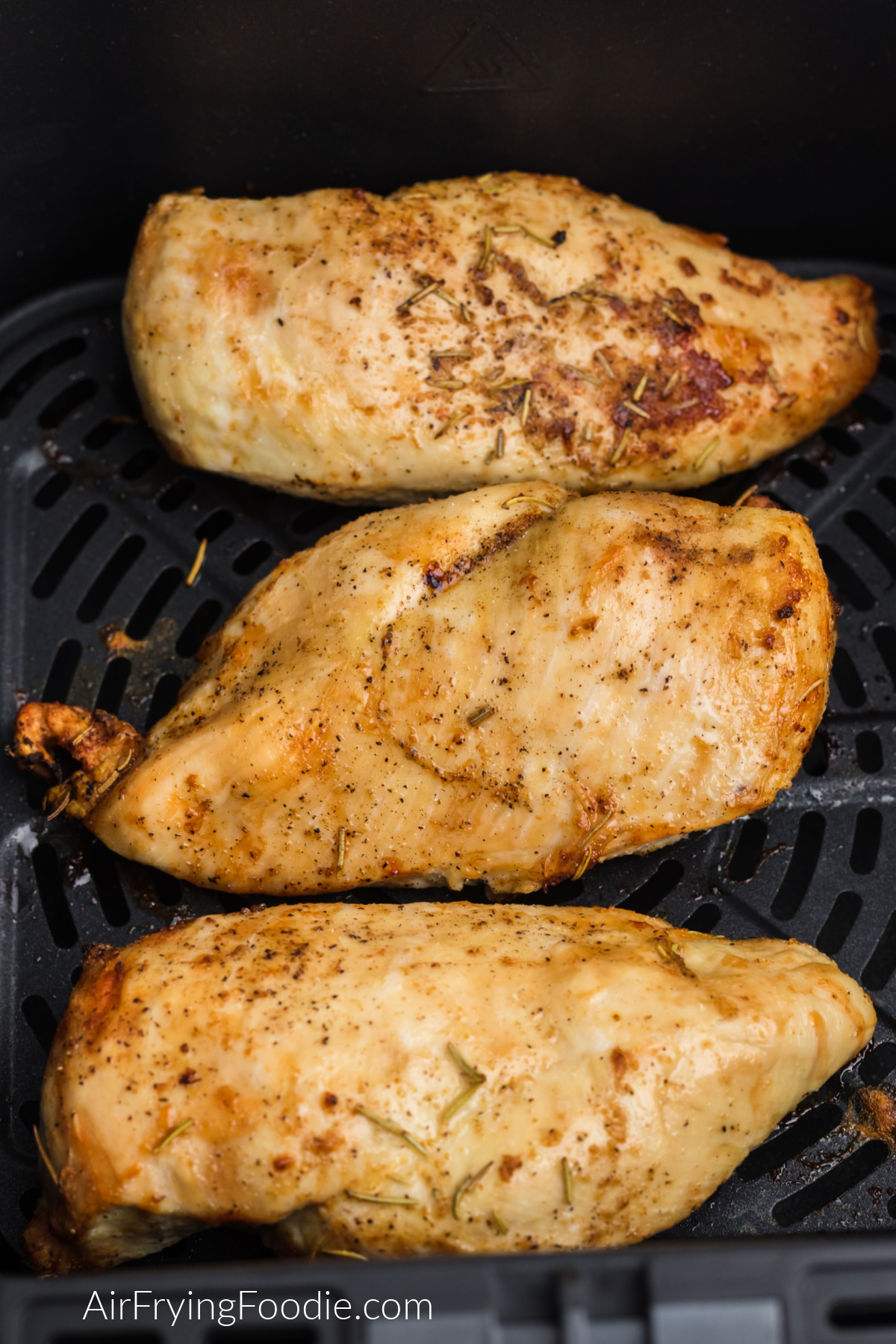 Seasoned grilled chicken breast in the air fryer.