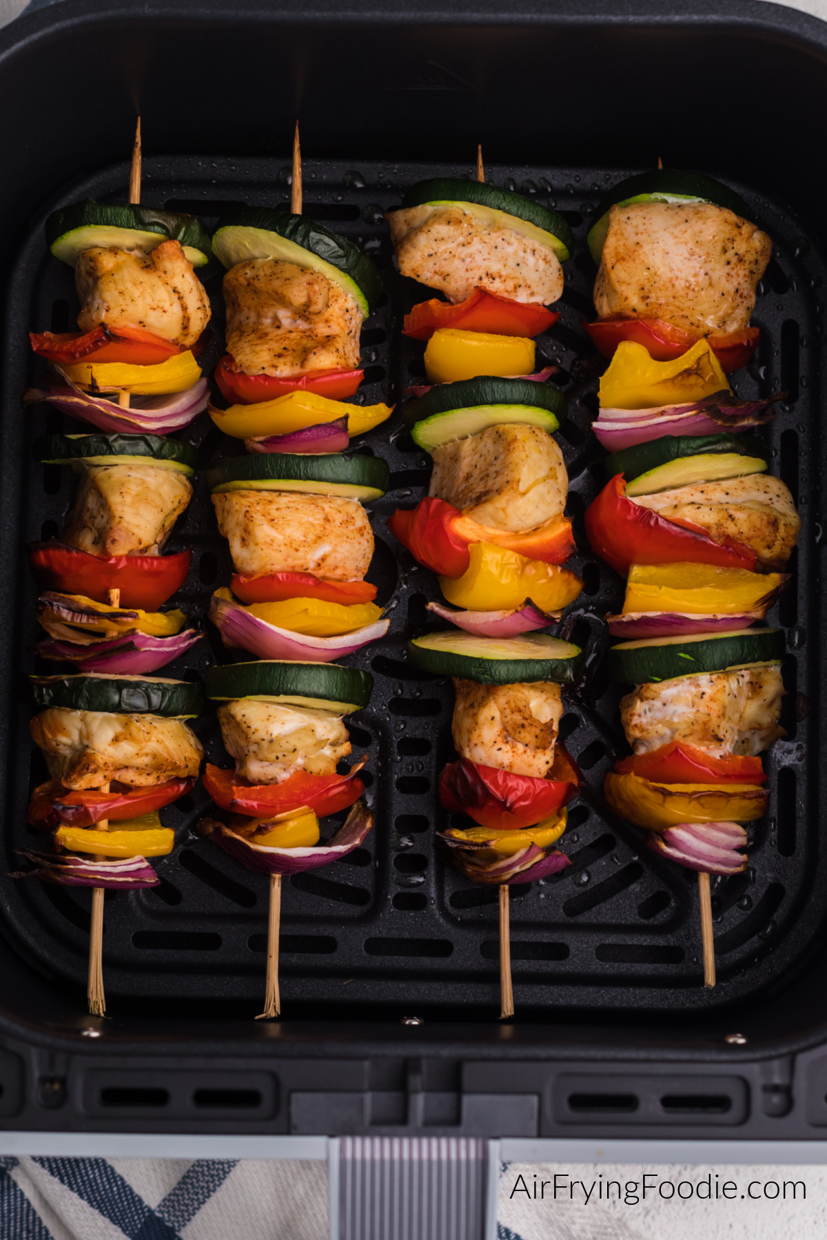 Chicken kabobs in the basket of the air fryer ready to serve.