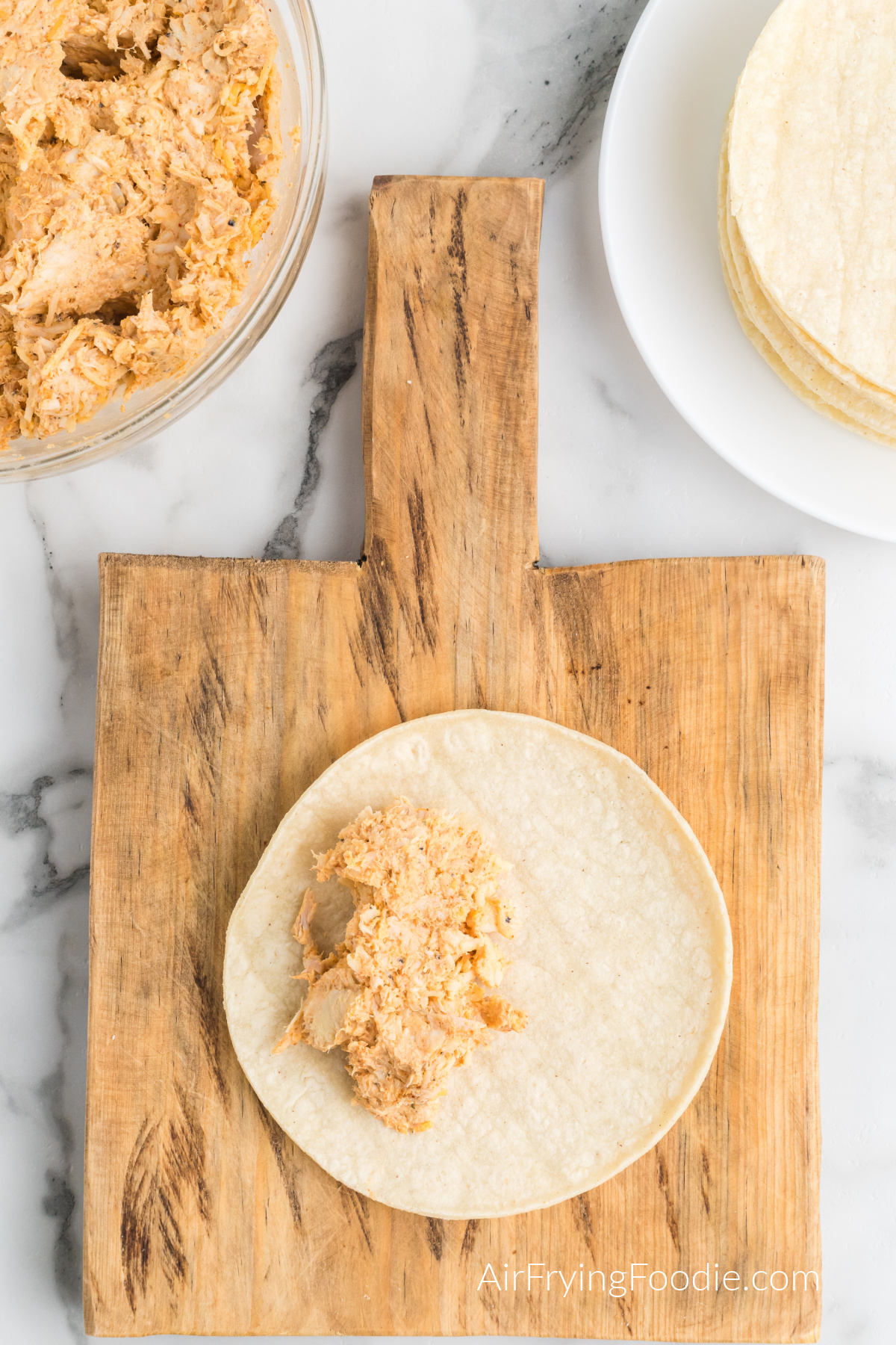 Chicken mixture placed into a tortilla shell.