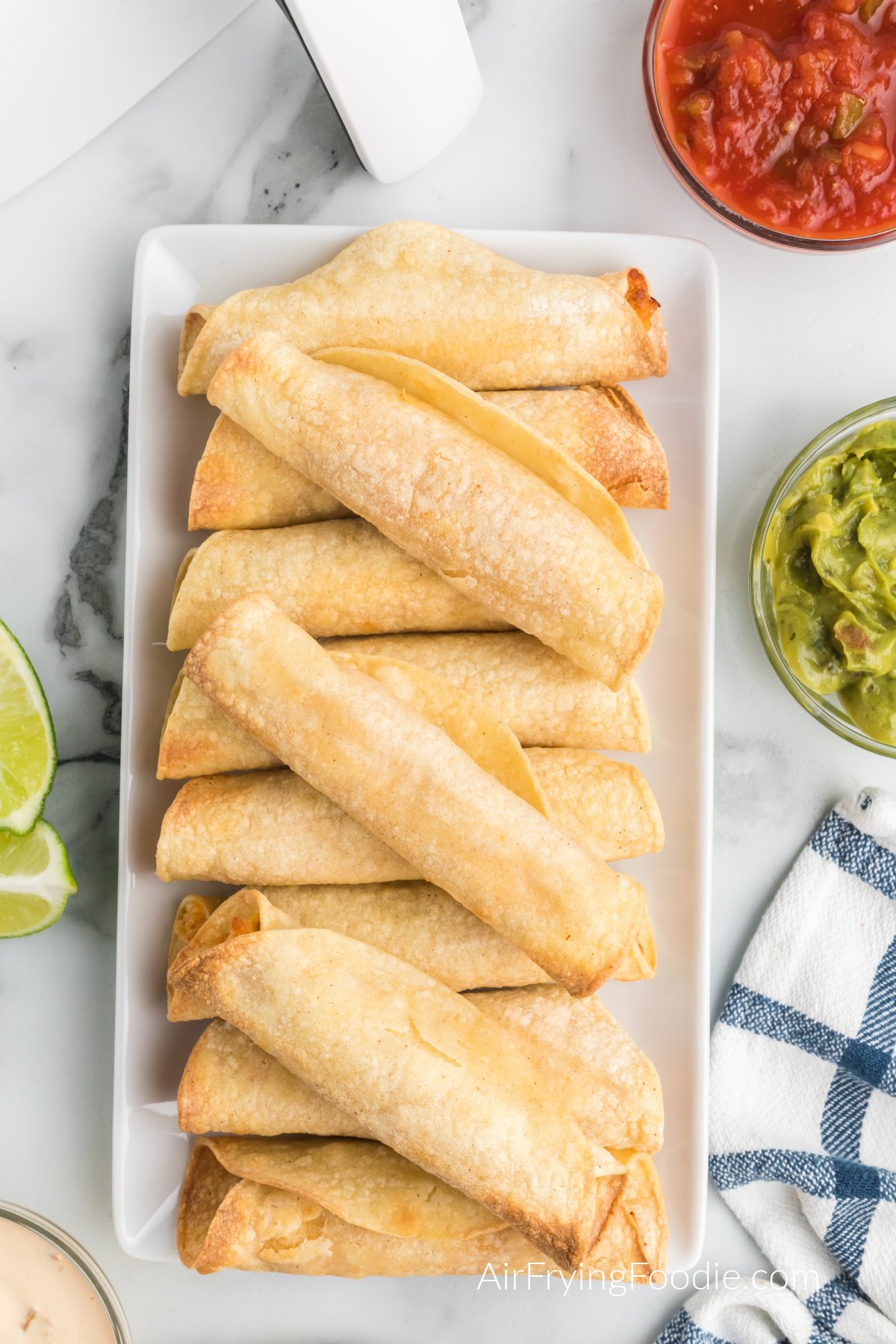 Chicken taquitos on a serving tray ready to be served.