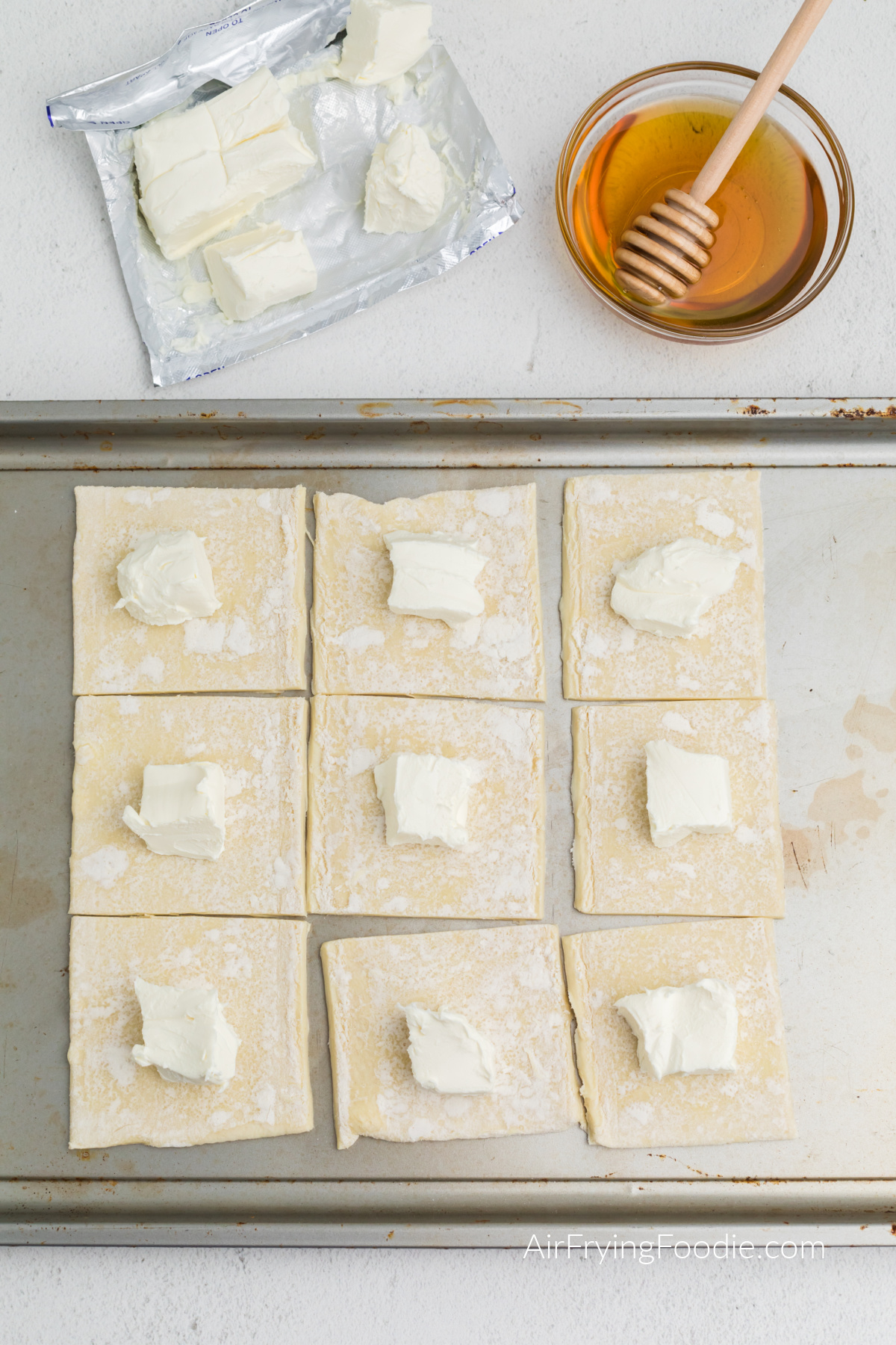 Cream cheese places into the middle of the puff pastry squares.
