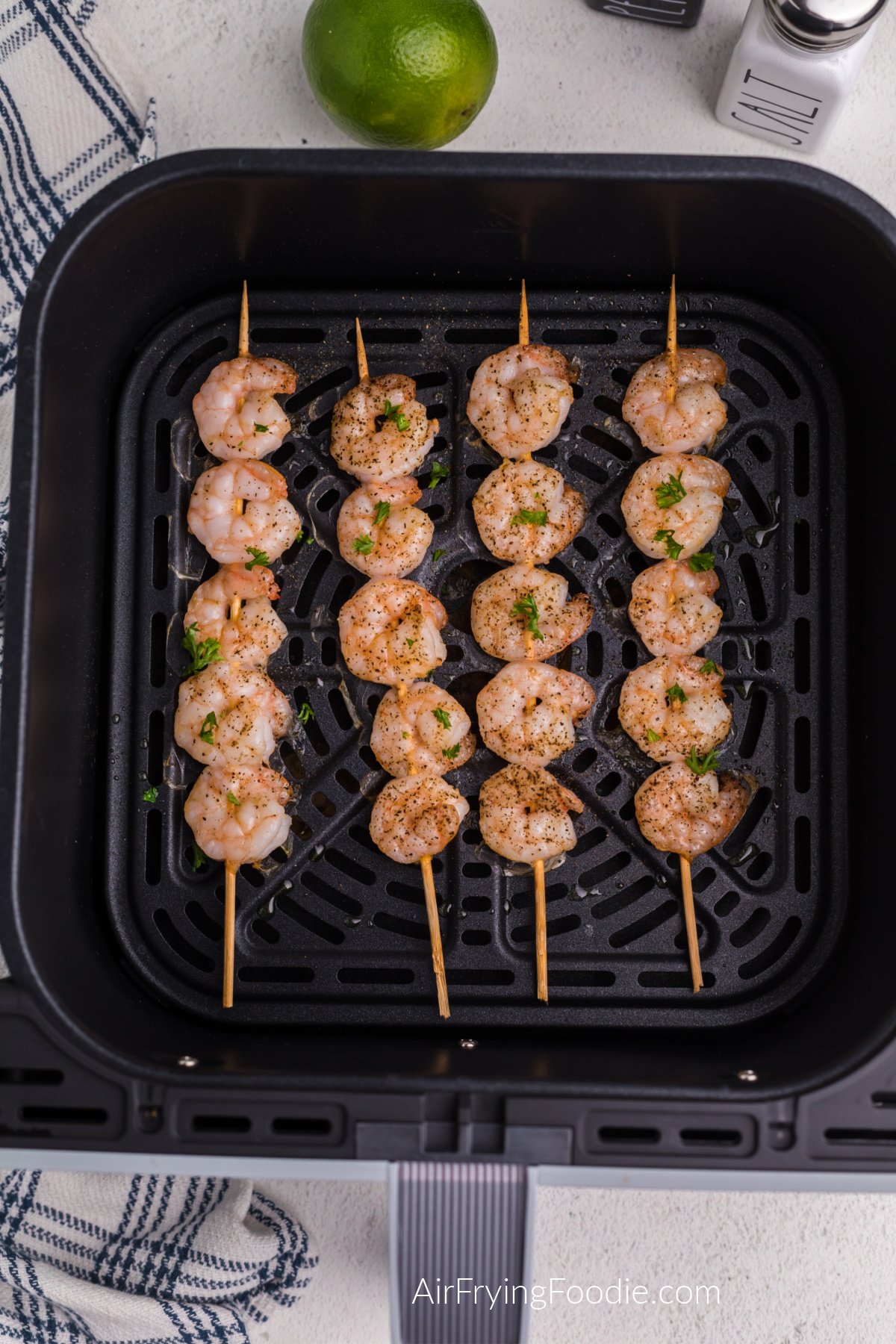 Air fried shrimp skewers in the air fryer basket.