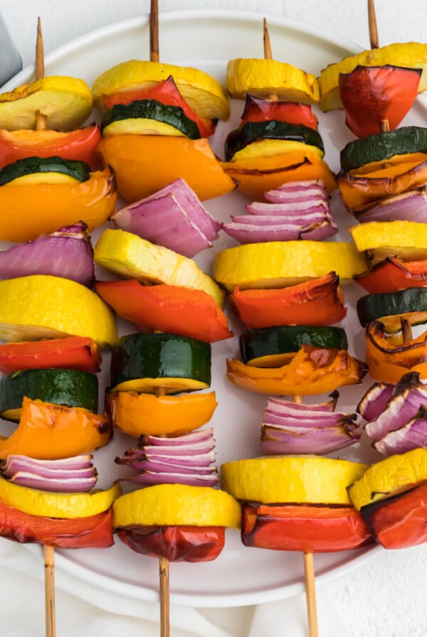 Vegetable kabobs made in the air fryer and served on a white plate.