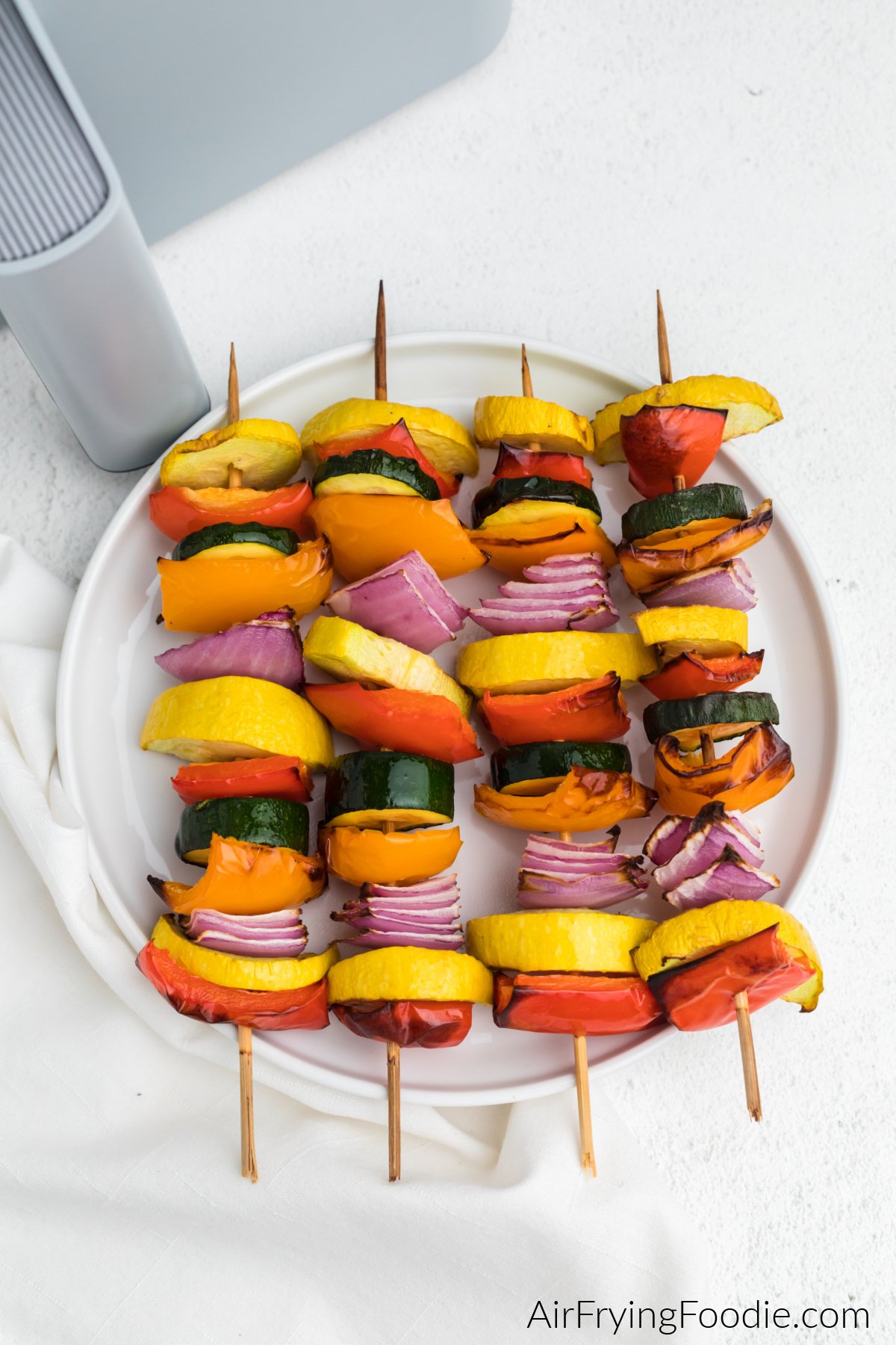 Vegetable Kabobs that were made in the air fryer, served on a white plate. 