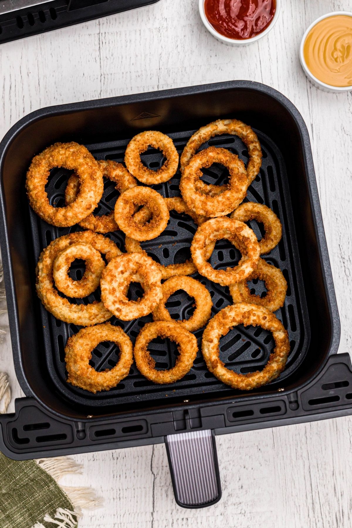 Golden frozen alexia crispy onion rings in the air fryer basket