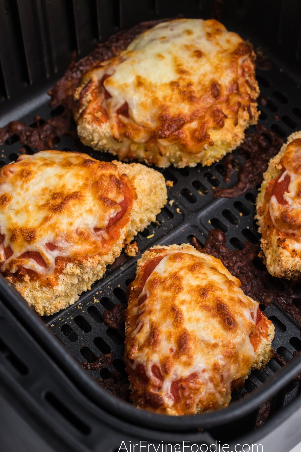 chicken parmesan in the basket of the air fryer. 