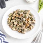 Golden fried seasoned okra pieces in a white plate.