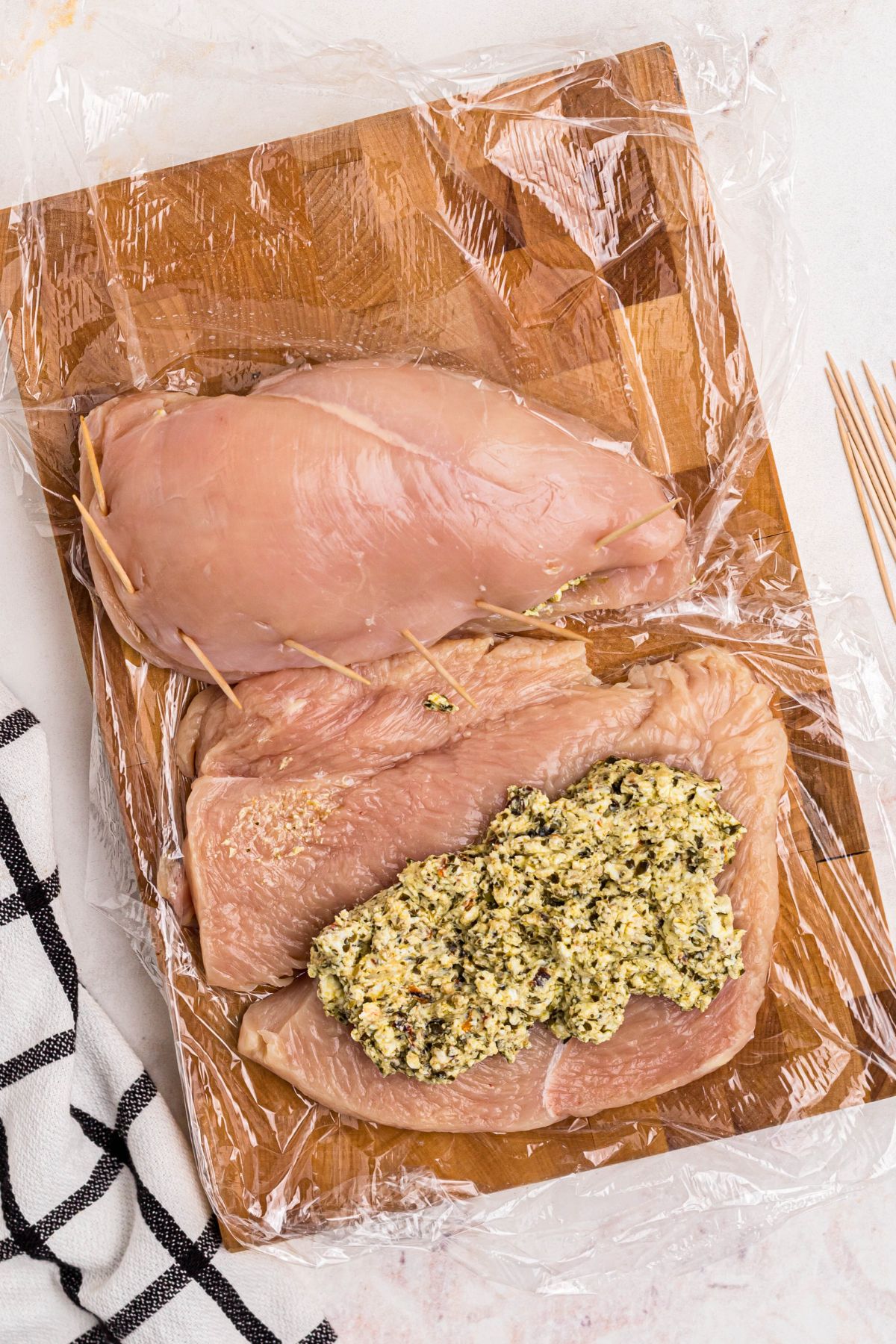 Cream cheese mixture placed in the center of chicken breast and then wrapped in chicken and sealed with toothpicks.