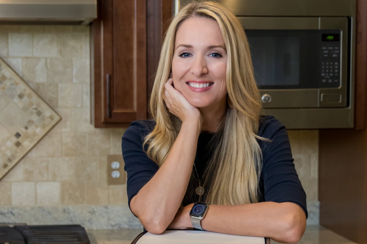 Author, content creator, food blogger, and recipe developer for airfryingfoodie.com, jennifer west in a kitchen. 