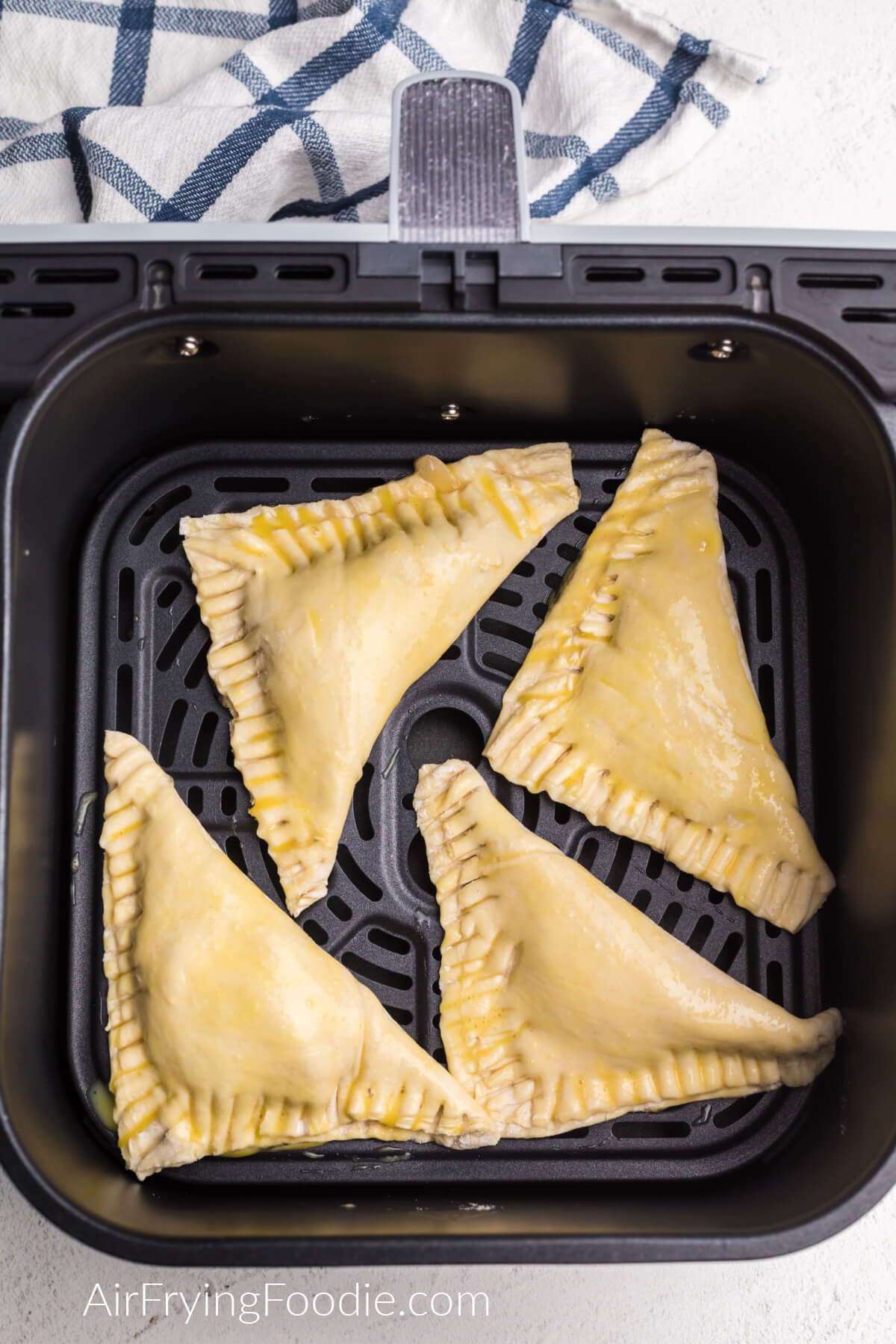 Apple turnovers in the basket of the air fryer.
