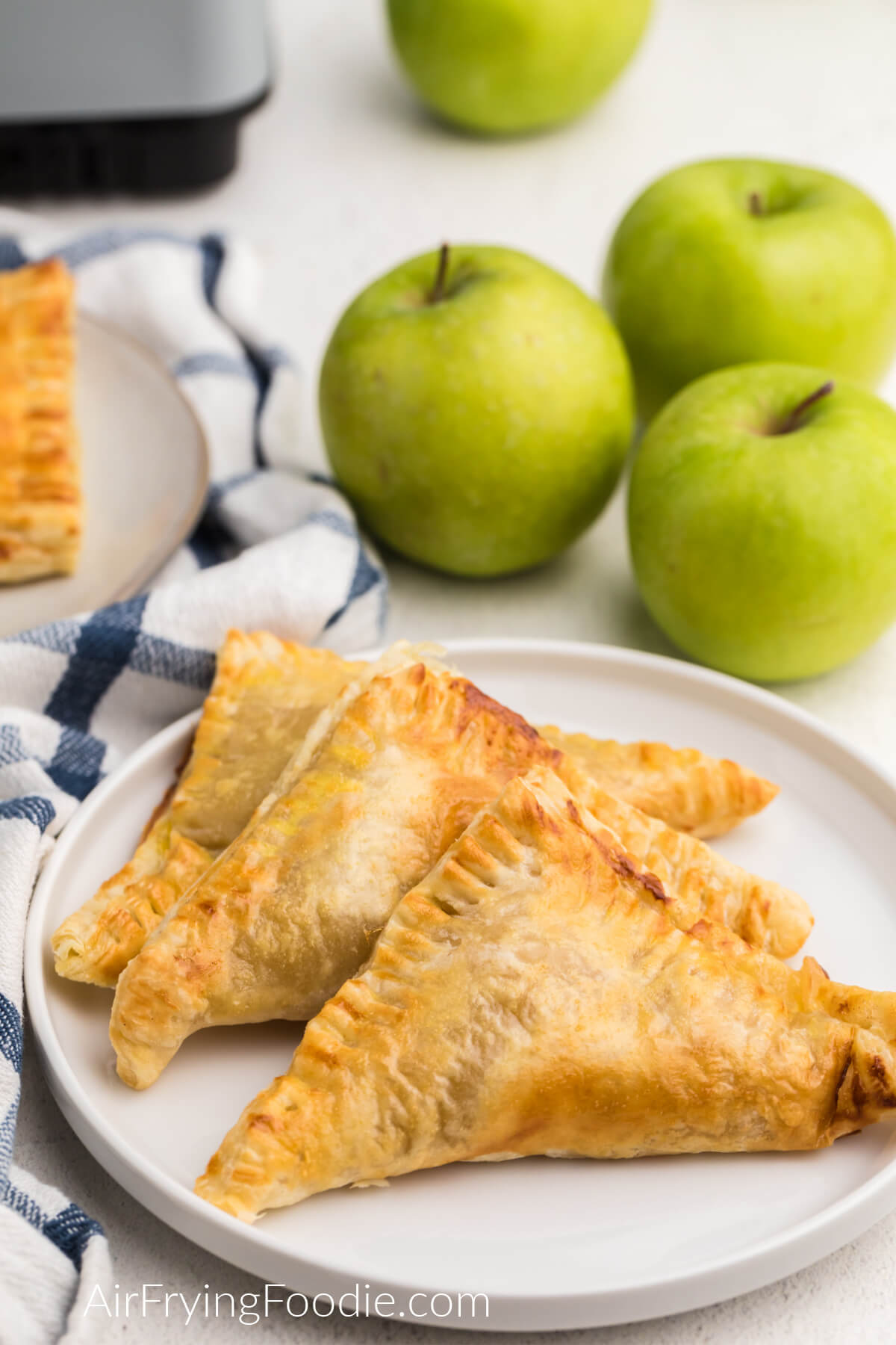 Apple turnovers made in the air fryer served on a white plate. 