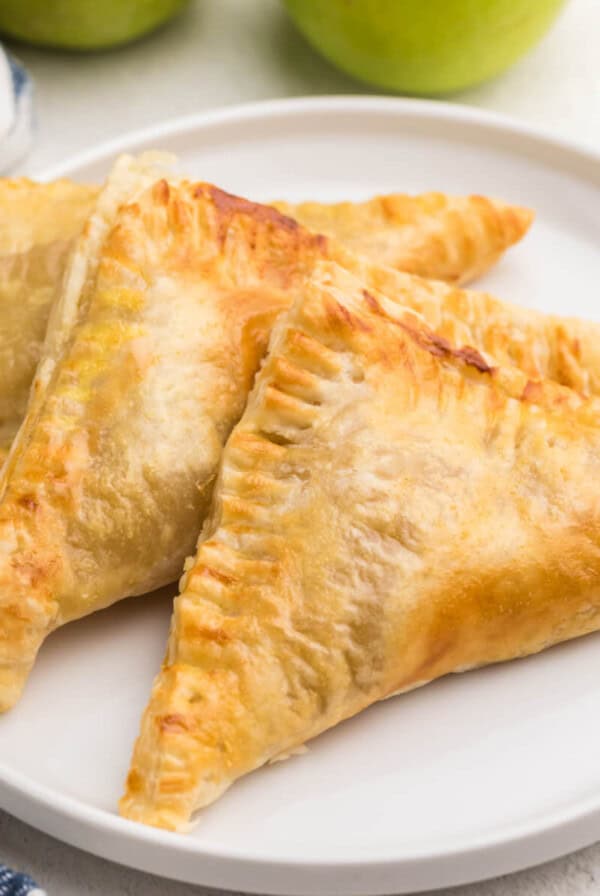 Air fried apple turnovers on a white plate, ready to eat.