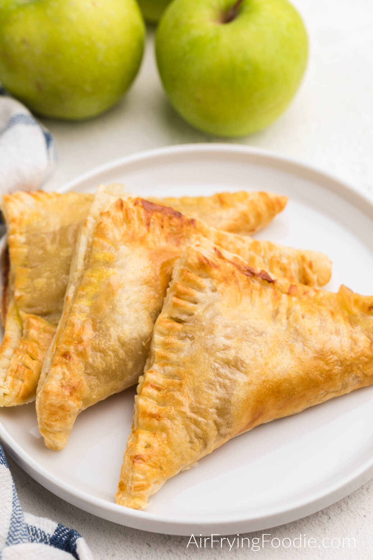 Apple turnovers made in the air fryer and served on a white plate. 