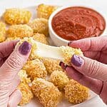 Cheese being pulled apart after being melted in the air fryer.