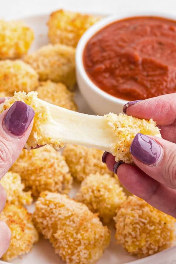 Cheese being pulled apart after being melted in the air fryer.