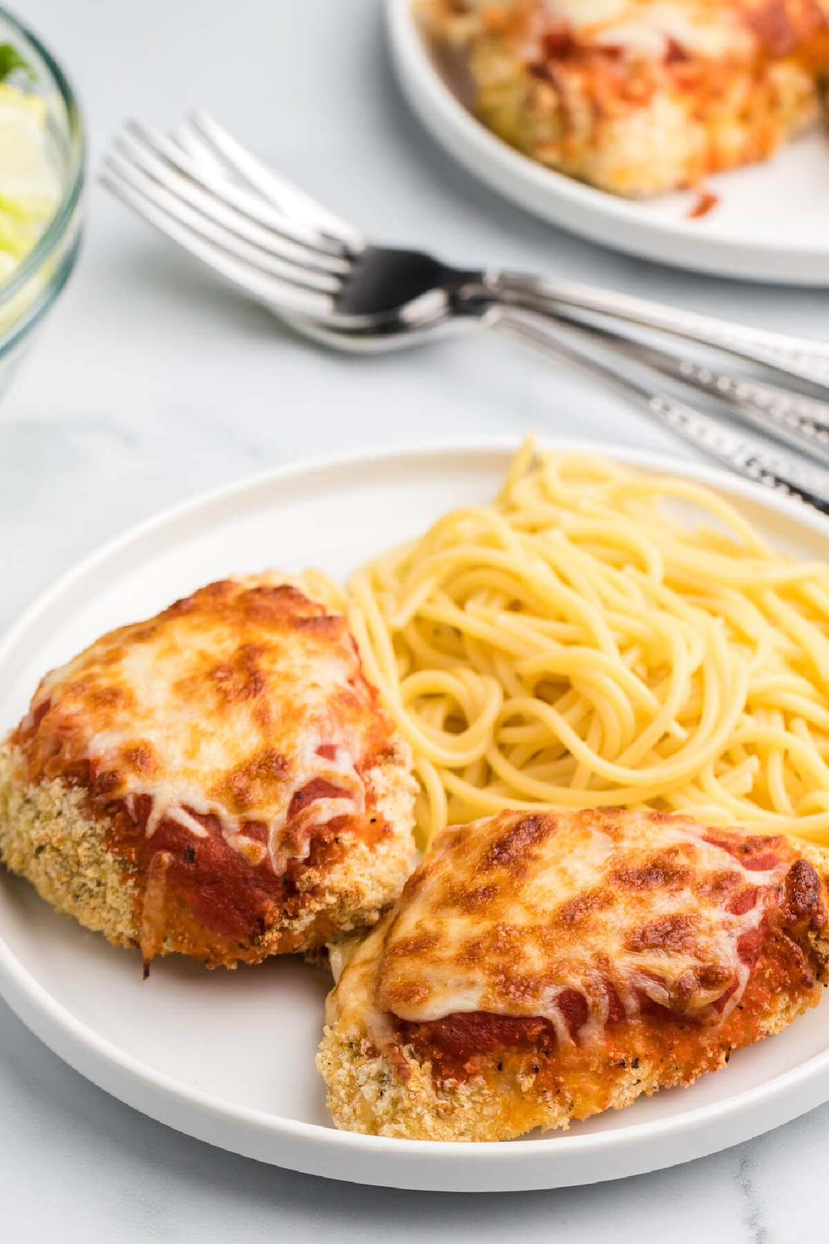Air Fryer Chicken parmesan on a plate with noodles.