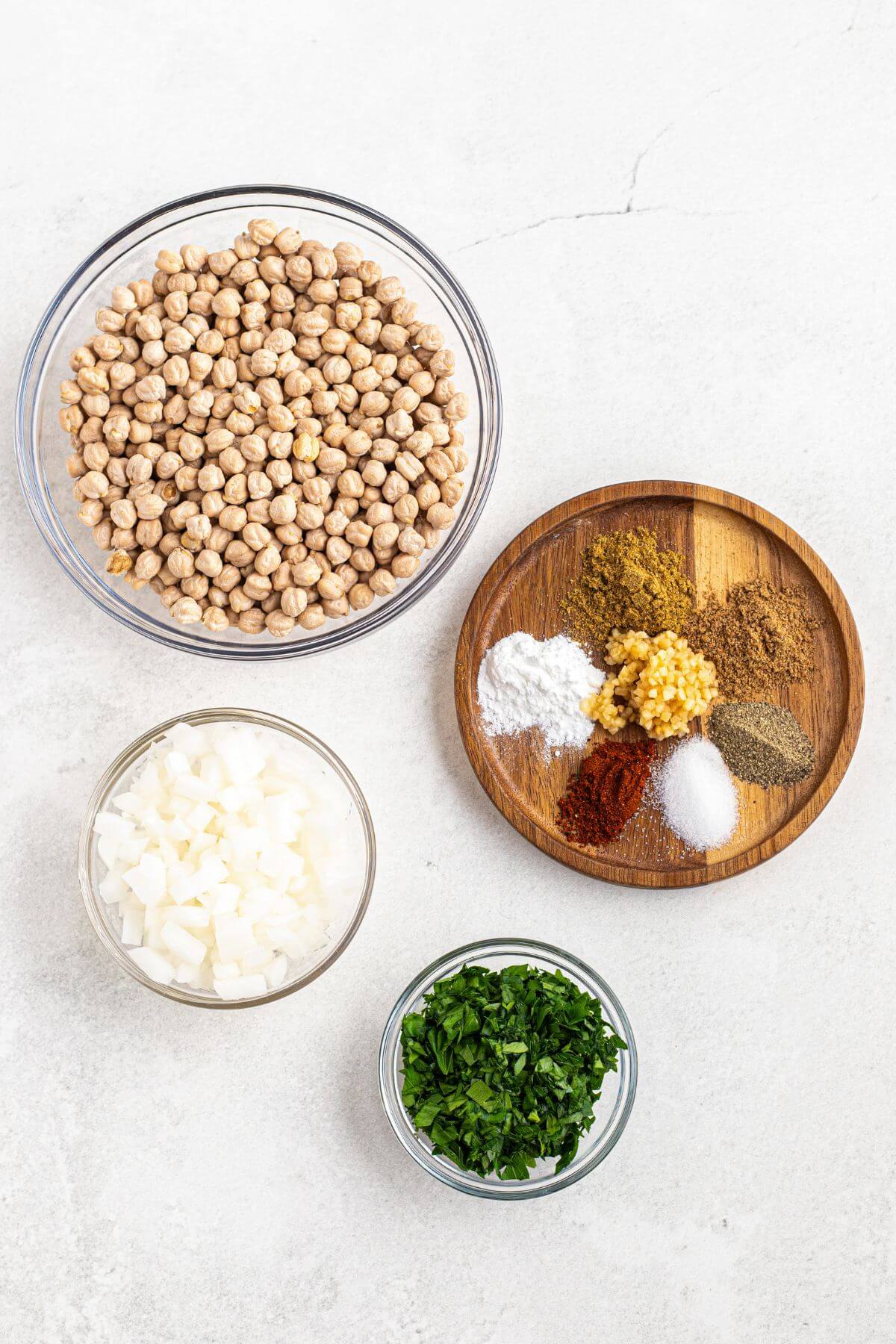 Ingredients to make falafels measured on a white table. 
