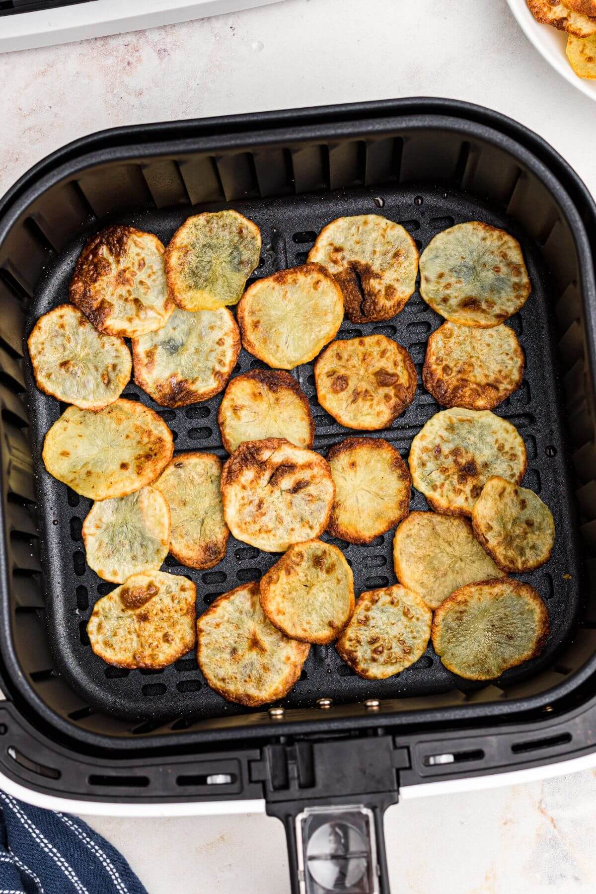 Potato chips cooked in the air fryer basket.