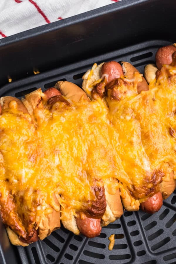 Air Fried Chili cheese dogs in the air fryer basket, ready to serve.