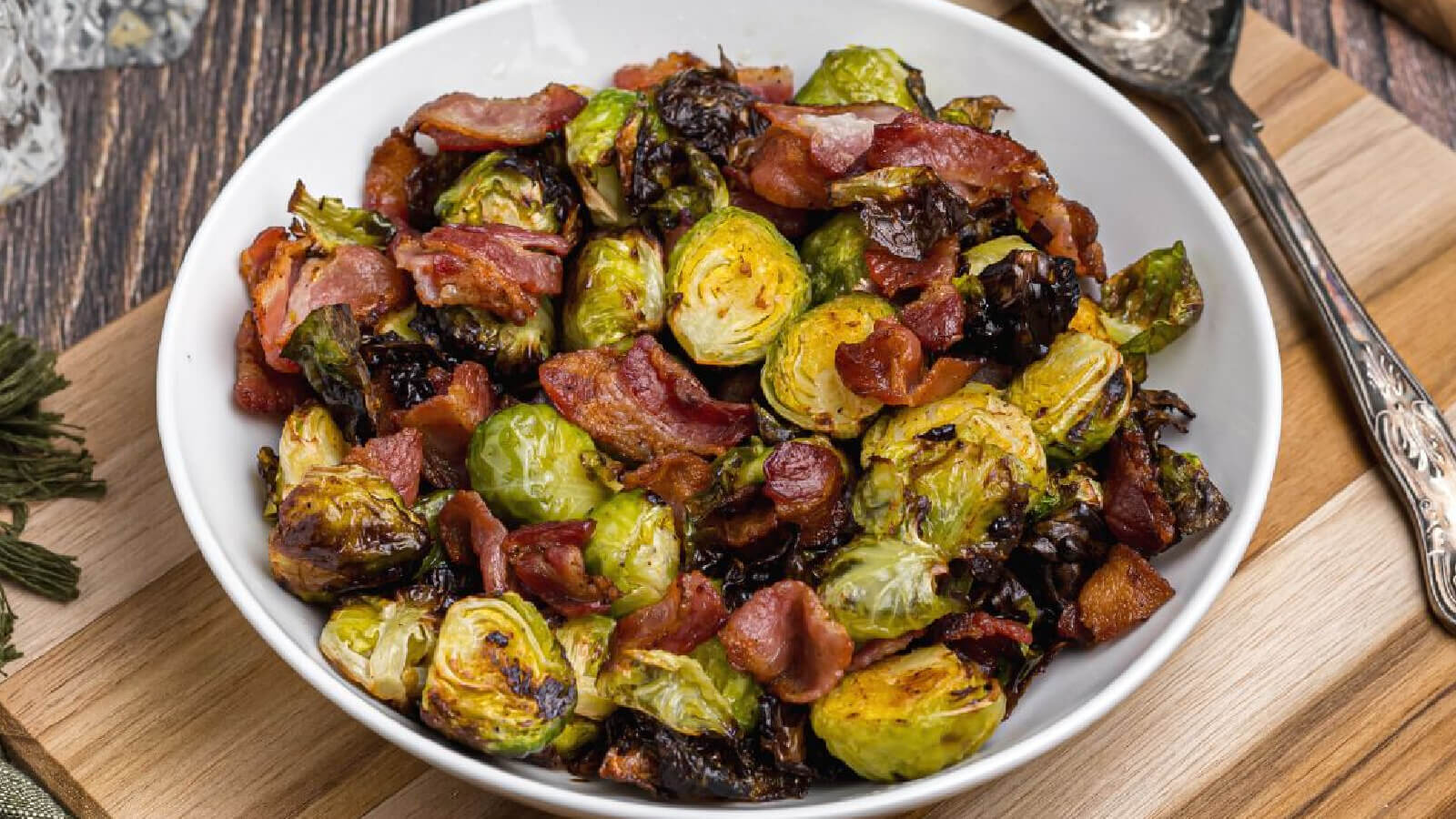 Bowl of air fryer brussels sprouts with bacon.