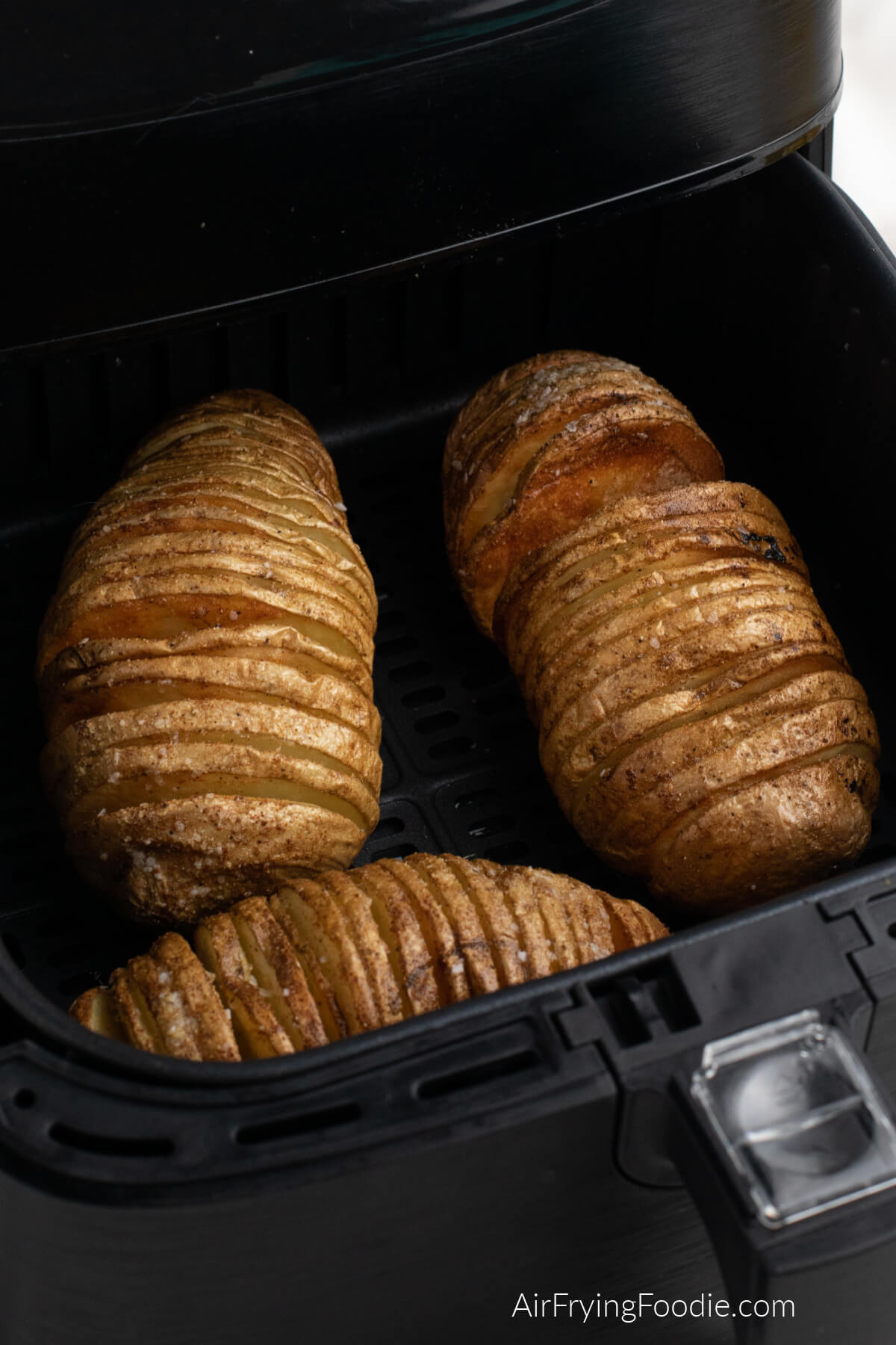 Hasselback potatoes in the air fryer basket. 