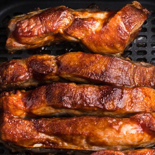 Ribs being reheated in the basket of the air fryer.