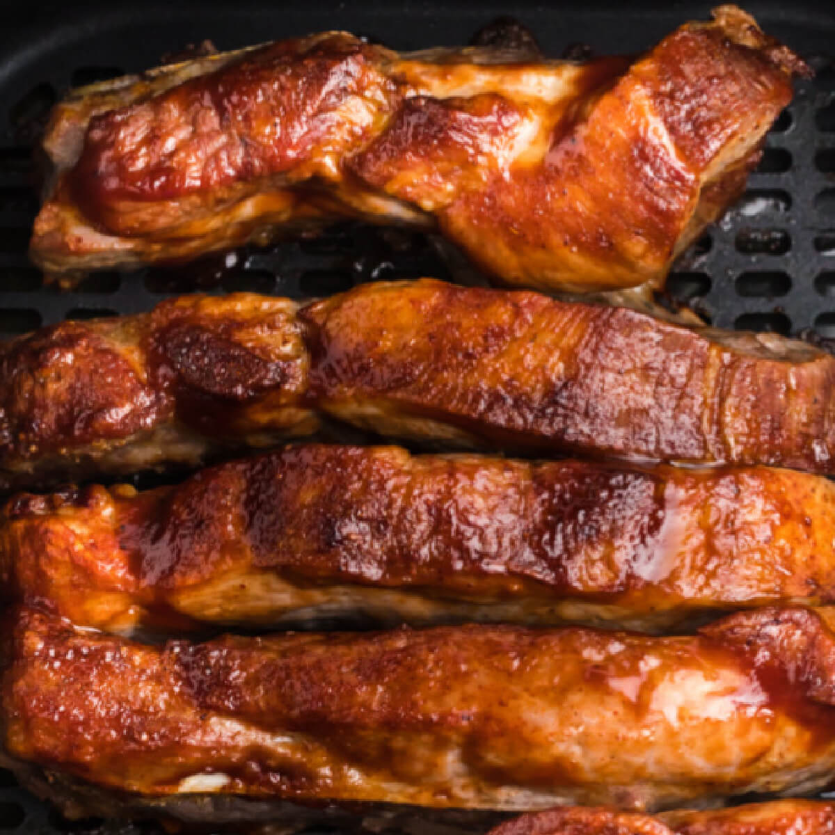 Ribs being reheated in the basket of the air fryer.