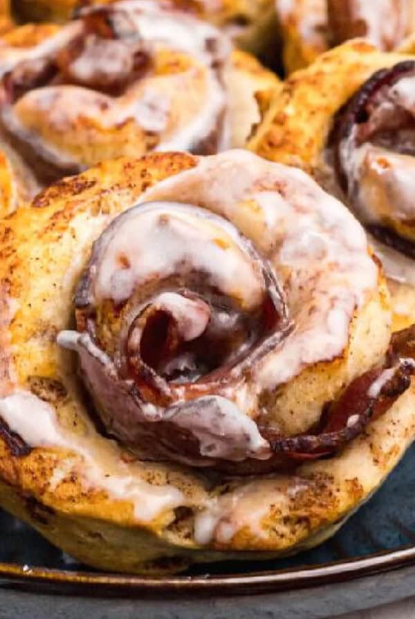 air fried bacon cinnamon rolls on a blue plate, ready to serve.