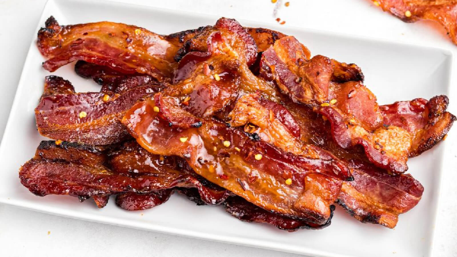 air fryer candied bacon on a white plate. 