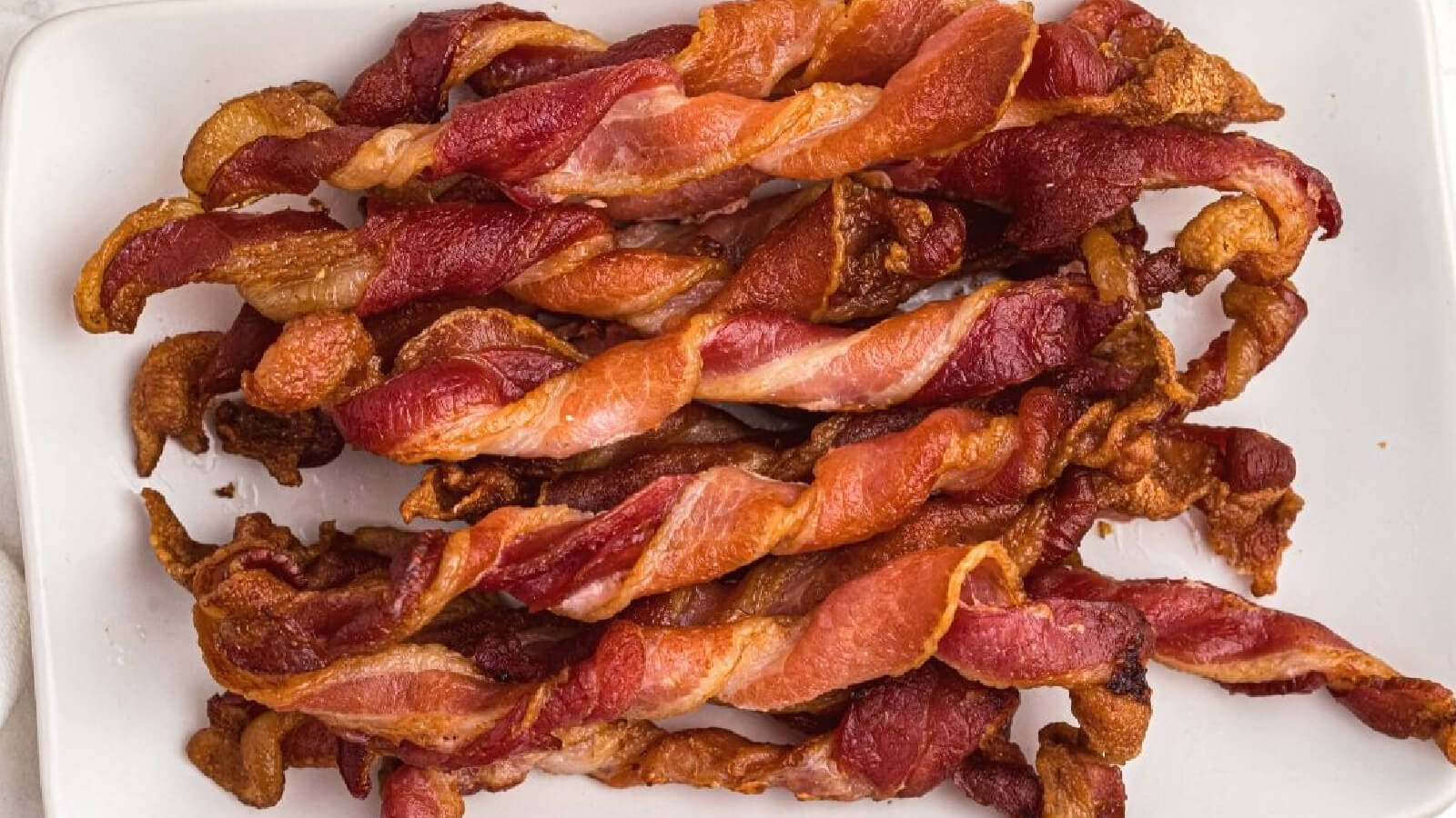 twisted bacon air fried, then served on a plate.