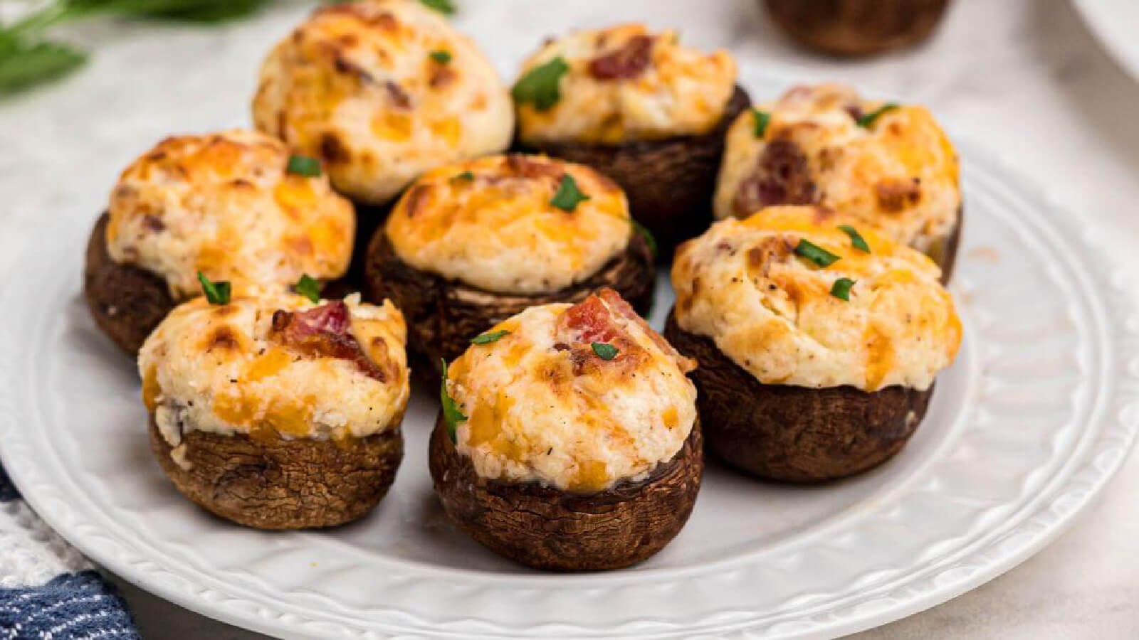 stuffed mushrooms made in the air fryer and placed on a white plate, ready to serve.