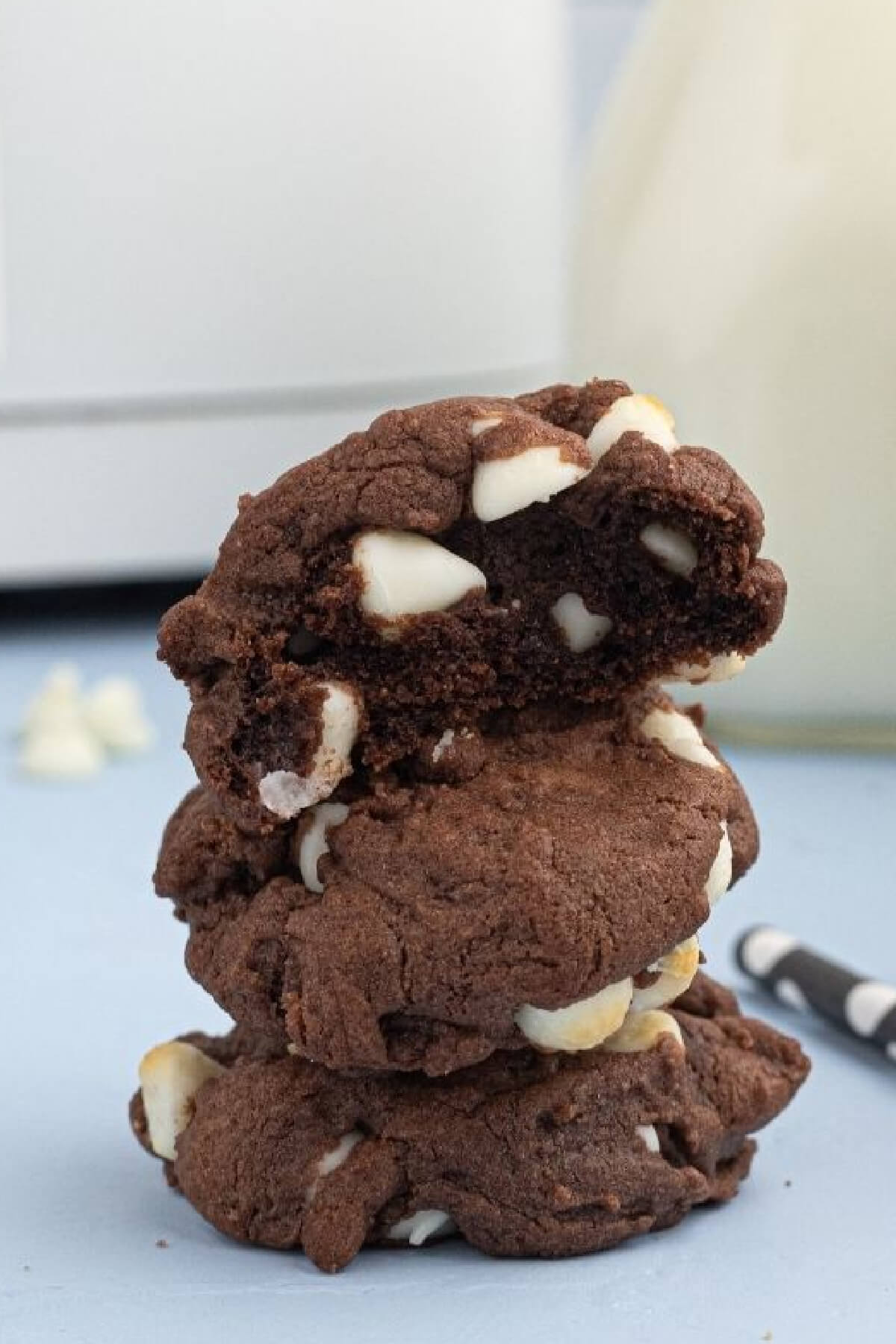 Stacked air fryer cake mix cookies with the top cookie missing a bite. 